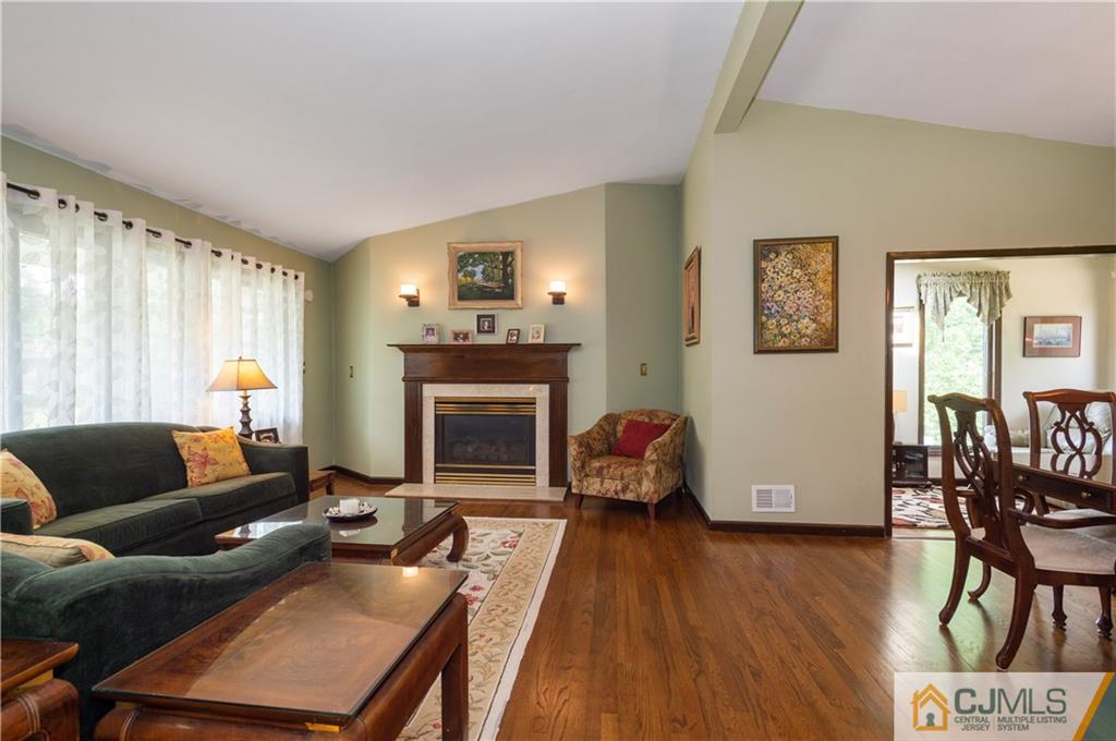 70 Wilk Road Edison, NJ 08837 - Photo 5 of 24 a living room with furniture and a fireplace