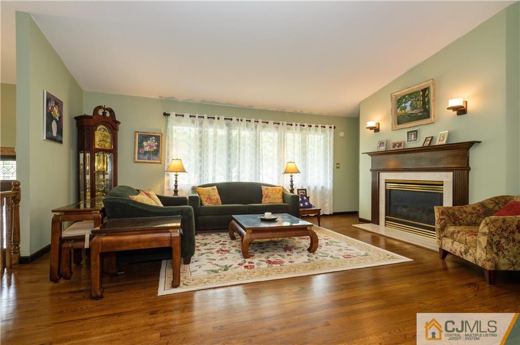 70 Wilk Road Edison, NJ 08837 - Photo 6 of 24 a living room with furniture and a fireplace