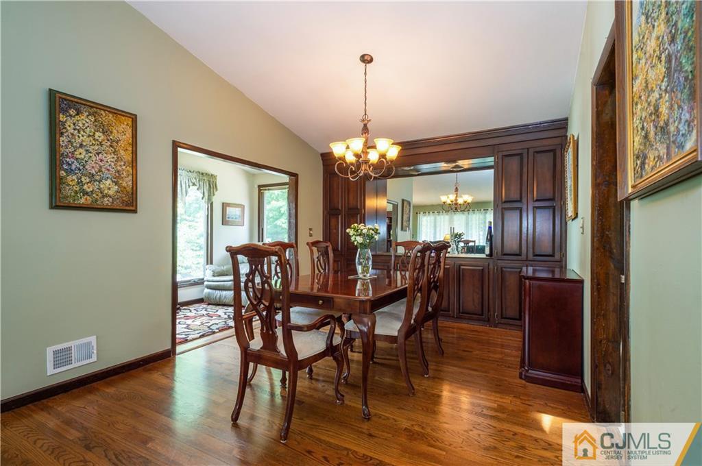 70 Wilk Road Edison, NJ 08837 - Photo 8 of 24 a dining room with furniture a chandelier and wooden floor