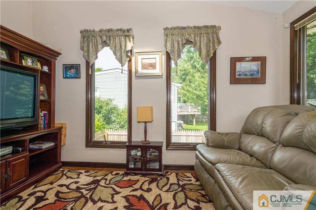 70 Wilk Road Edison, NJ 08837 - Photo 10 of 24 a living room with furniture and a flat screen tv