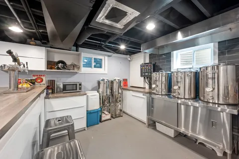 a kitchen with refrigerator and white cabinets