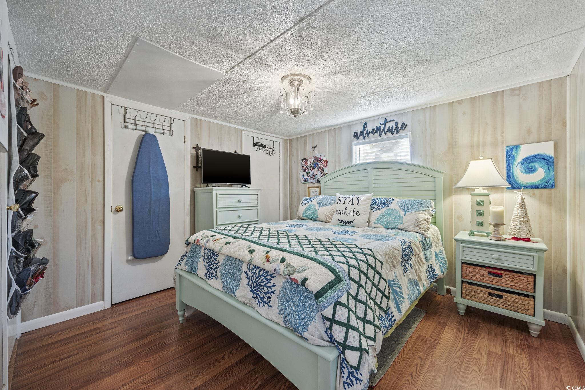 80 Princess Drive North Myrtle Beach, SC 29582 - Photo 10 of 27 Bedroom with wood finished floors and a textured ceiling