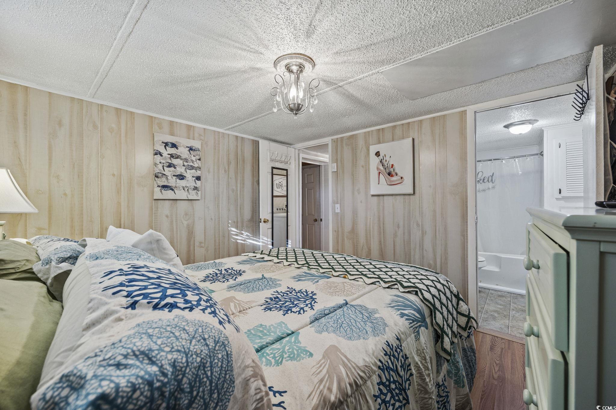80 Princess Drive North Myrtle Beach, SC 29582 - Photo 11 of 27 Bedroom with wood finished floors and wooden walls