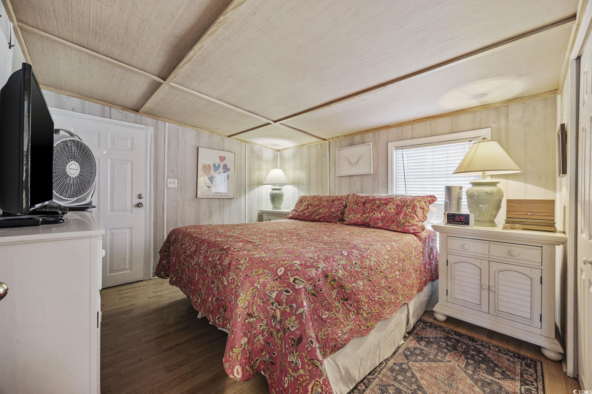 80 Princess Drive North Myrtle Beach, SC 29582 - Photo 13 of 27 Bedroom featuring wood finished floors and wooden walls