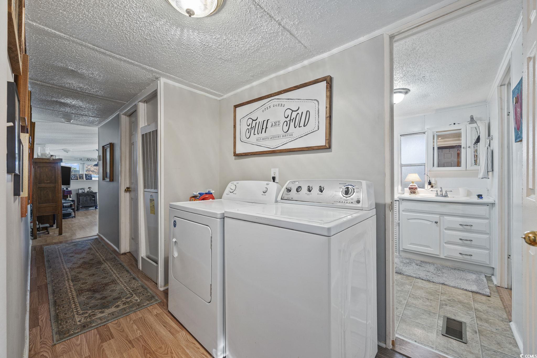 80 Princess Drive North Myrtle Beach, SC 29582 - Photo 16 of 27 Laundry area with a textured ceiling, washing machine and dryer, and light wood-type flooring