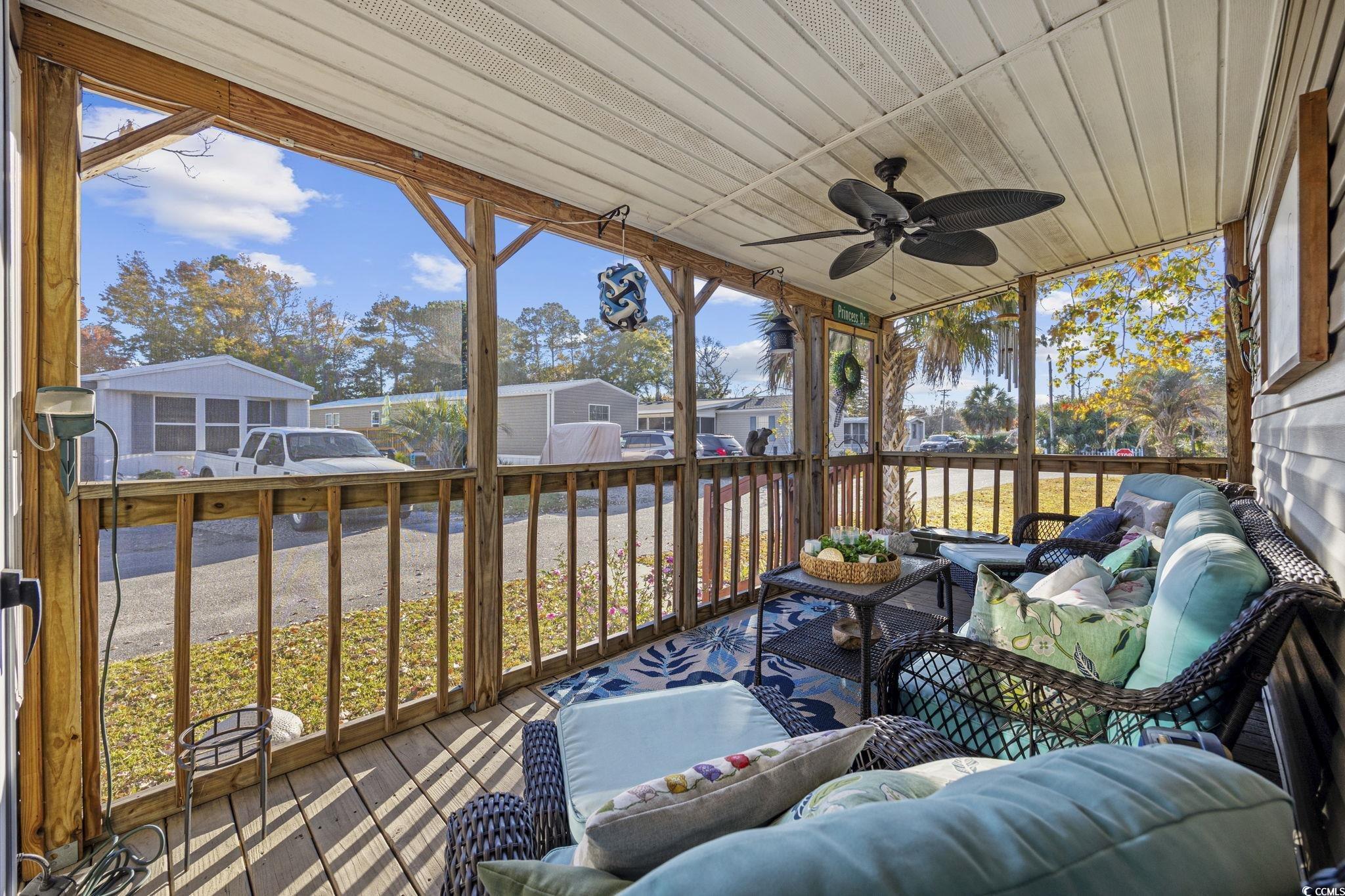 80 Princess Drive North Myrtle Beach, SC 29582 - Photo 20 of 27 Sunroom with outdoor lounge area, a ceiling fan, and a residential view