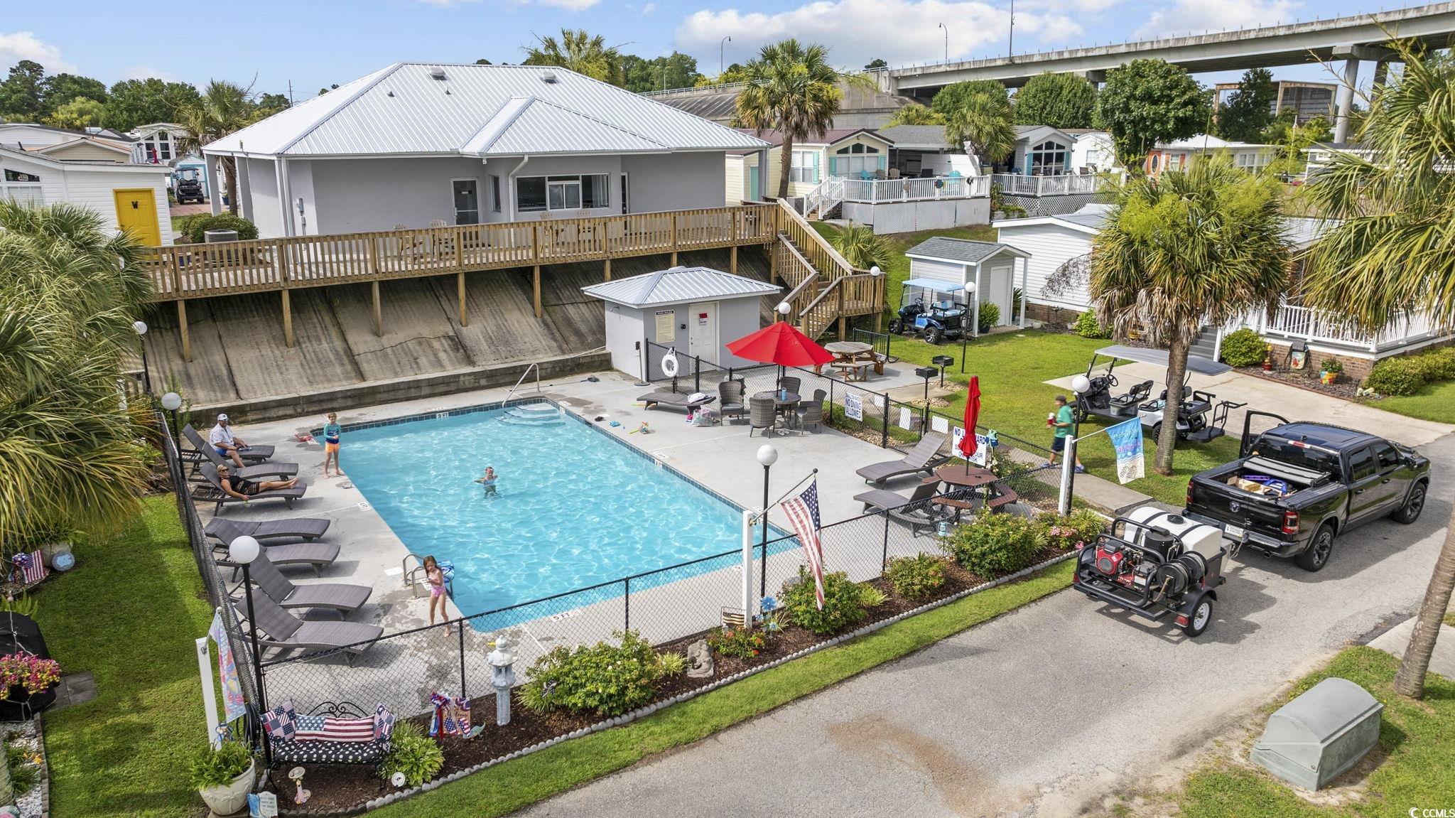 80 Princess Drive North Myrtle Beach, SC 29582 - Photo 24 of 27 Community pool featuring a residential view, stairway, and a patio