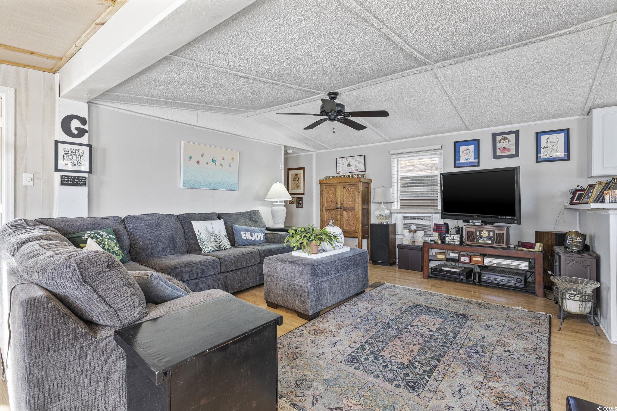 80 Princess Drive North Myrtle Beach, SC 29582 - Photo 5 of 27 Living area with light wood-style flooring, vaulted ceiling, and a ceiling fan