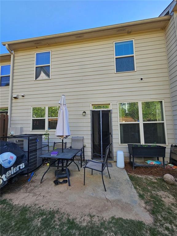 5747 Radford Loop Fairburn, GA 30213 - Photo 29 of 36 a backyard of a house with outdoor seating