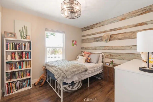 a bedroom with a bed and a bookshelf