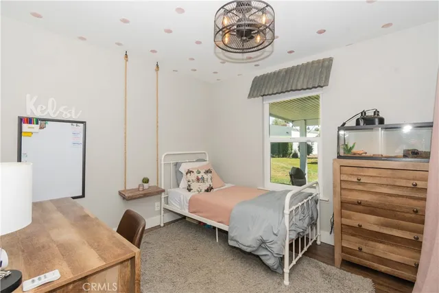 a bedroom with a bed and a chandelier