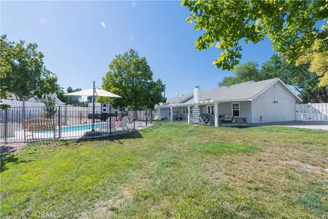 a view of a house with backyard and sitting area
