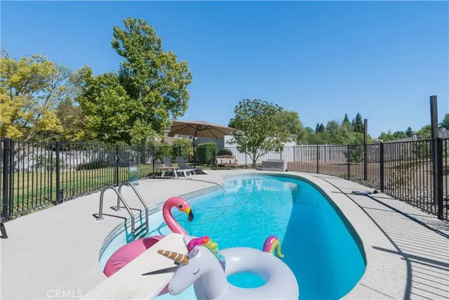 a swimming pool with outdoor seating and yard