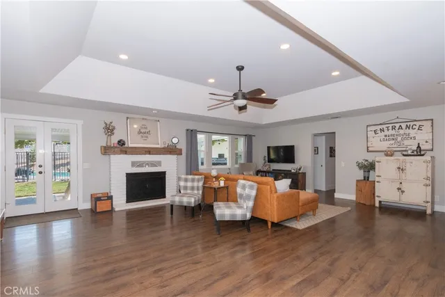 a living room with furniture a fireplace and wooden floor