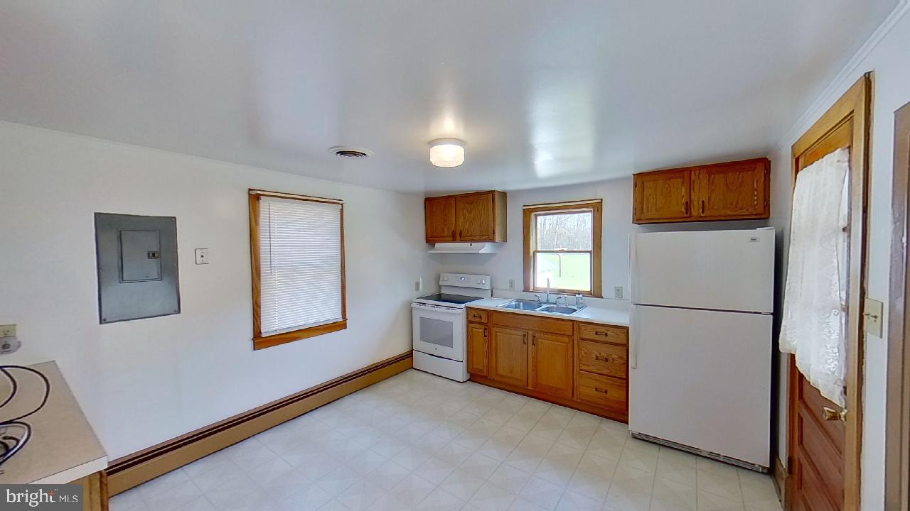 42464 Fairgrounds Road Leonardtown, MD 20650 - Photo 12 of 33 a kitchen with stainless steel appliances granite countertop a refrigerator sink and cabinets