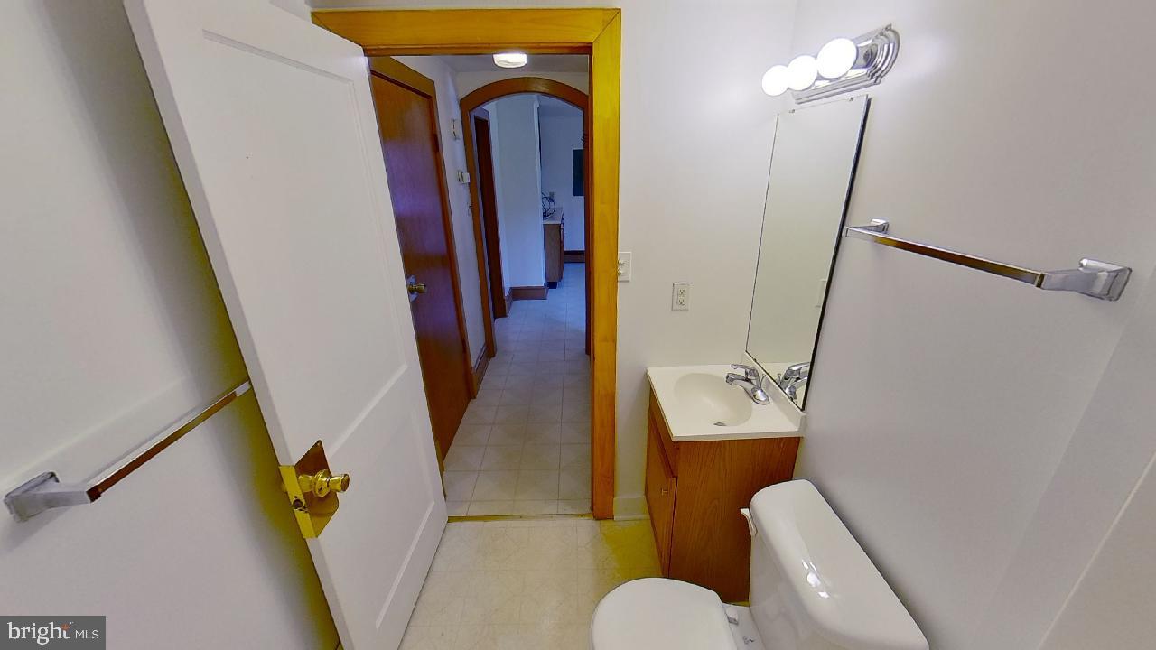 42464 Fairgrounds Road Leonardtown, MD 20650 - Photo 16 of 33 a bathroom with a sink and mirror with toilet
