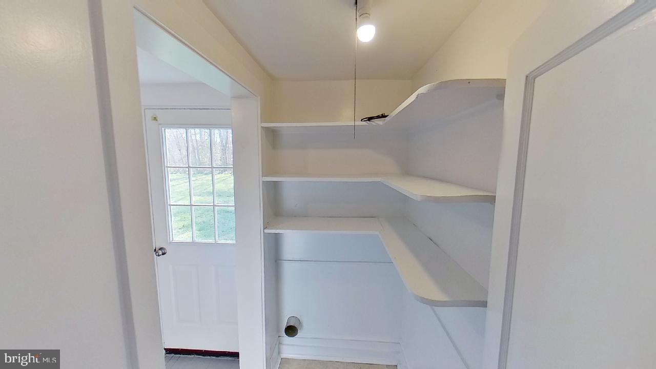 42464 Fairgrounds Road Leonardtown, MD 20650 - Photo 17 of 33 a view of walk in closet with empty racks