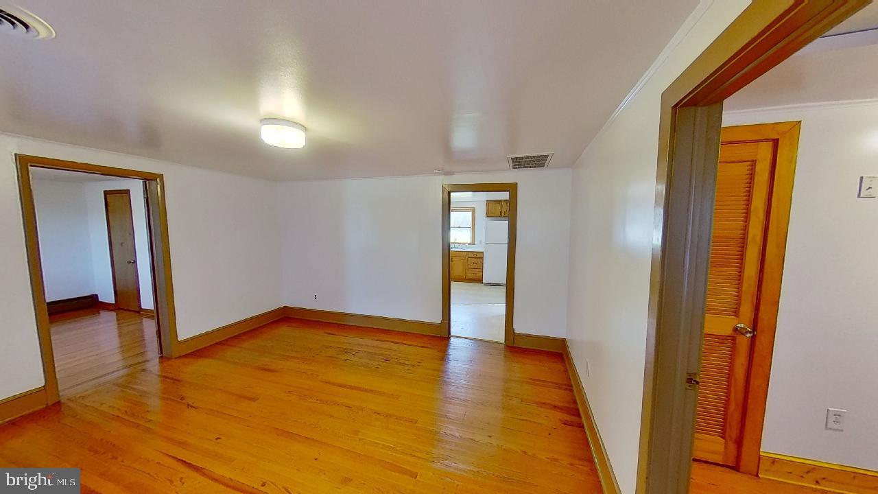 42464 Fairgrounds Road Leonardtown, MD 20650 - Photo 24 of 33 a view of an empty room with wooden floor and a window