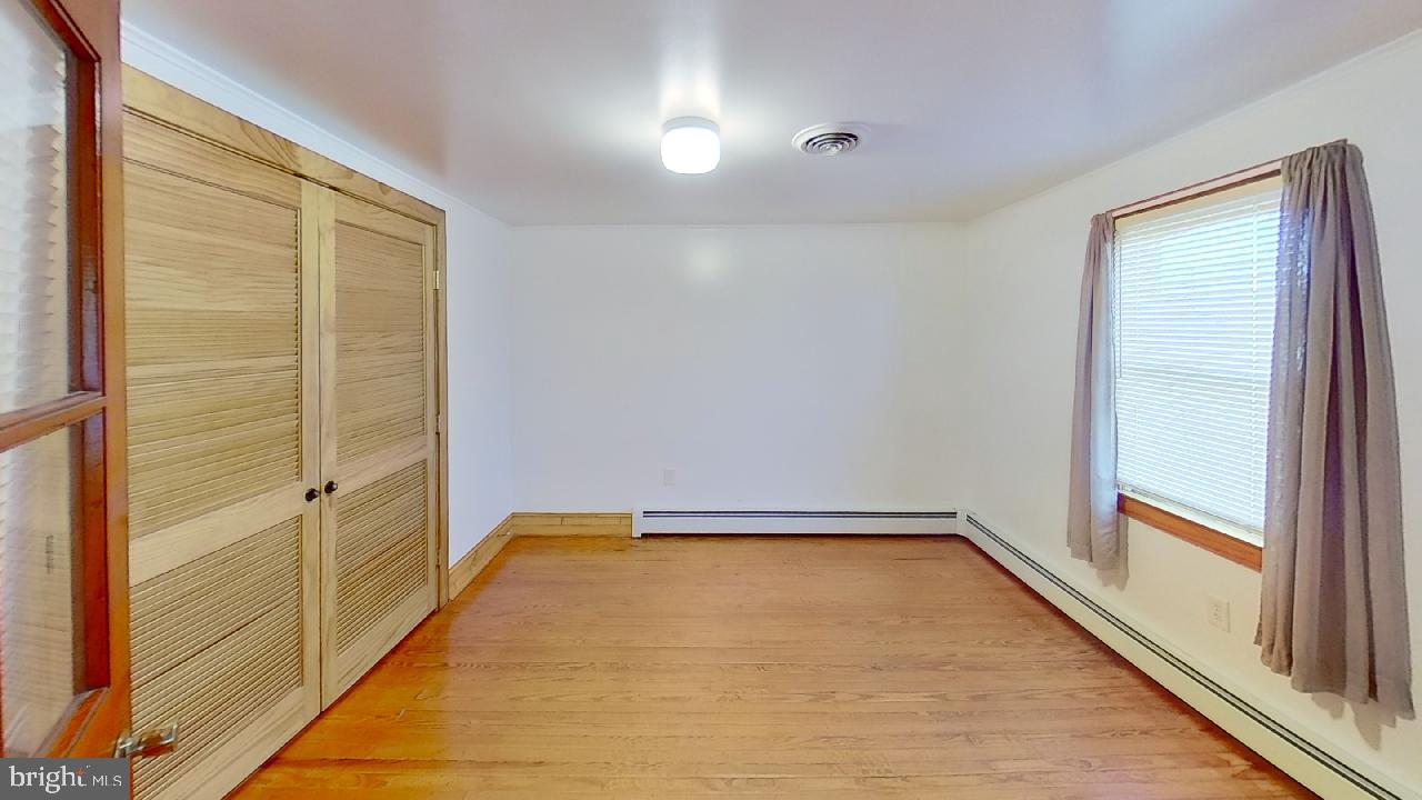 42464 Fairgrounds Road Leonardtown, MD 20650 - Photo 30 of 33 a view of a room with wooden floor and brick walls