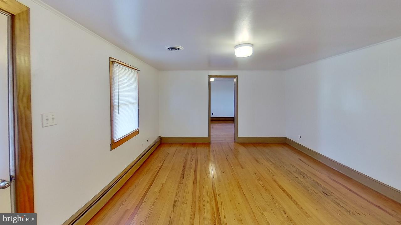 42464 Fairgrounds Road Leonardtown, MD 20650 - Photo 33 of 33 a view of empty room with wooden floor and fan