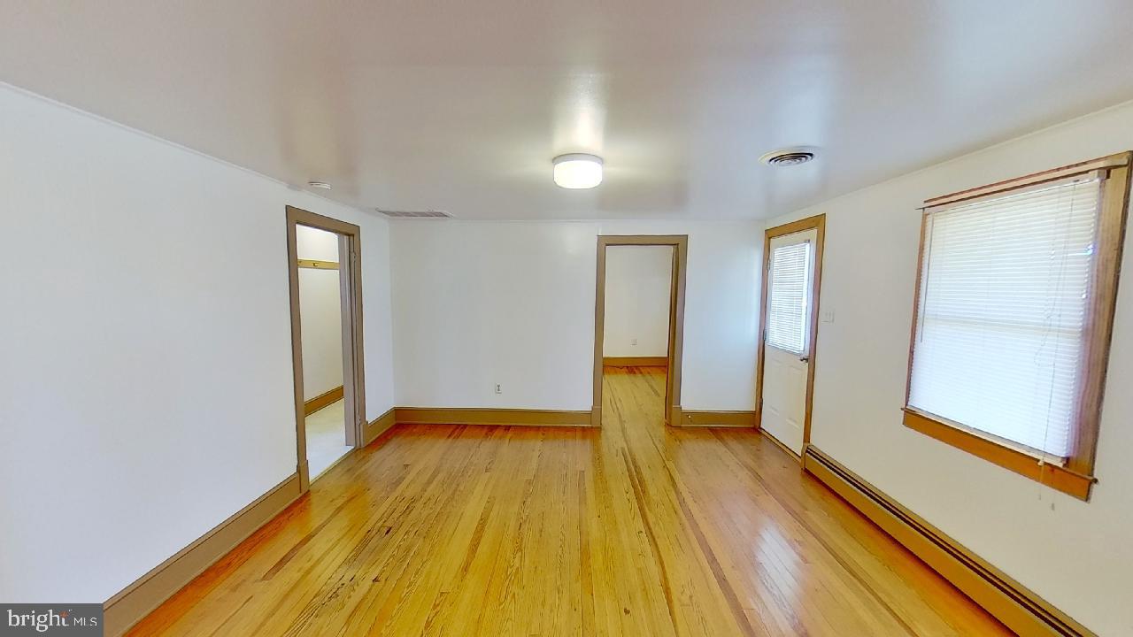 42464 Fairgrounds Road Leonardtown, MD 20650 - Photo 8 of 33 a view of a room with wooden floor and brick walls