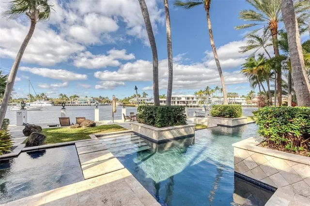 a living room with furniture chandelier and a large window