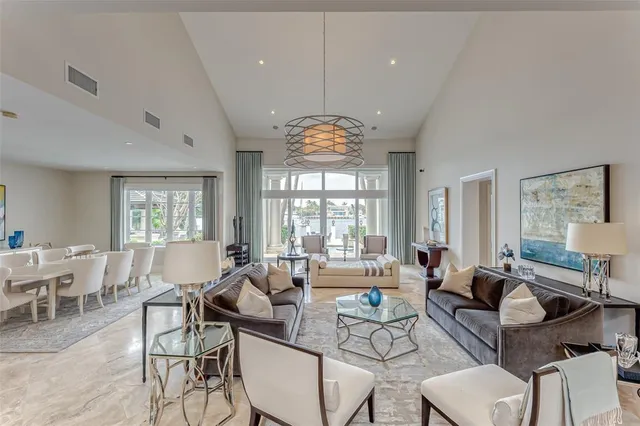 a living room with furniture large window and chairs