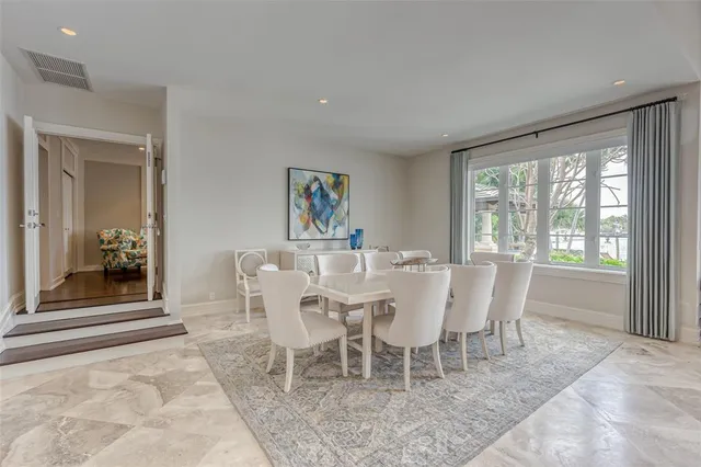 a kitchen with stainless steel appliances granite countertop a sink a stove and a wooden floors