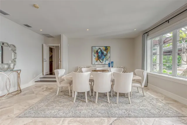 a kitchen with stainless steel appliances granite countertop a stove and a view of living room