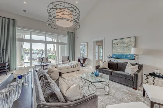 a large kitchen with kitchen island granite countertop a stove a sink a dining table and chairs