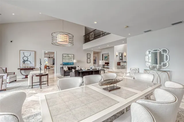 a large bedroom with a large bed and a chandelier