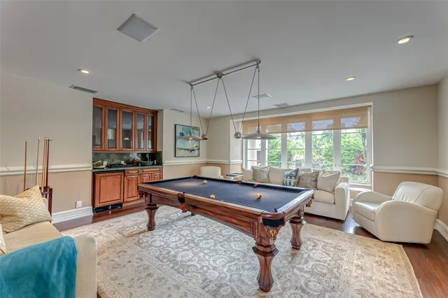 a view of a hallway with wooden floor and stairs