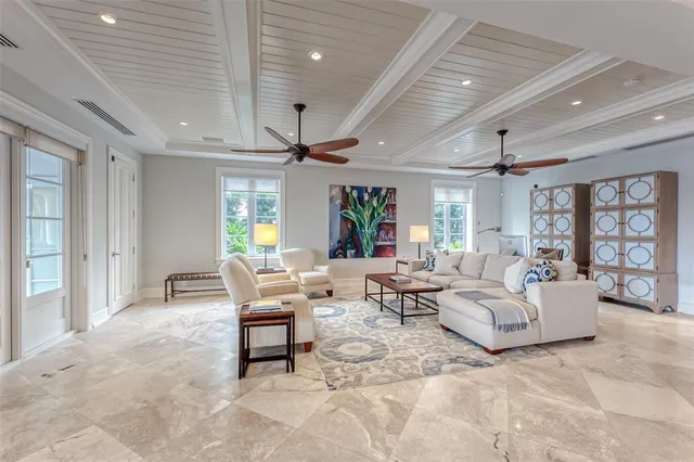 a view of staircase with lots of frames on wall and wooden floor