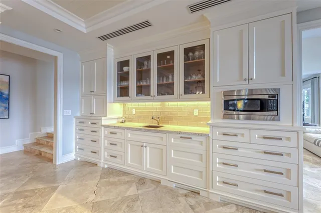 a bathroom with a sink a toilet and a large mirror