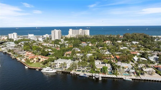 a view of a white house with a yard and potted plants
