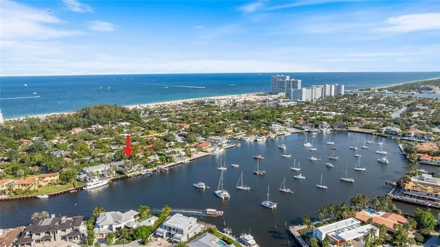 a living room with furniture a large window and a dining table