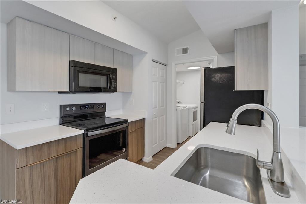 4720 St Croix Lane, Unit 135 Naples, FL 34109 - Photo 17 of 24 a kitchen with a sink stove and refrigerator