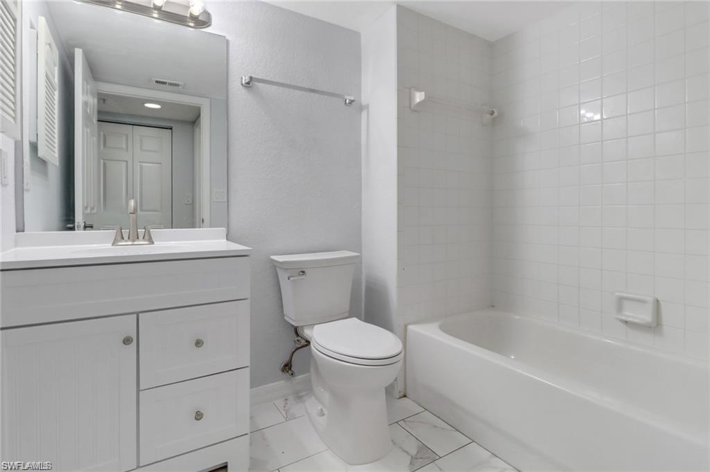 4720 St Croix Lane, Unit 135 Naples, FL 34109 - Photo 20 of 24 a bathroom with a sink a toilet and a bathtub