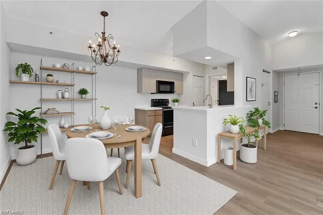 a view of a dining room with furniture wooden floor and chandelier