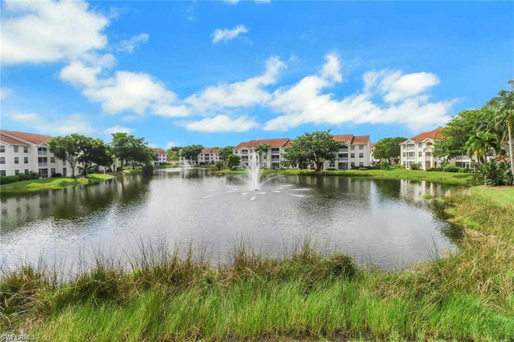 4720 St Croix Lane, Unit 135 Naples, FL 34109 - Photo 24 of 24 a view of a lake with a yard