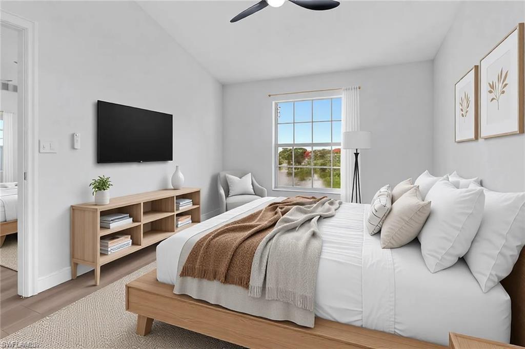 4720 St Croix Lane, Unit 135 Naples, FL 34109 - Photo 4 of 24 a bedroom with a bed and a flat screen tv
