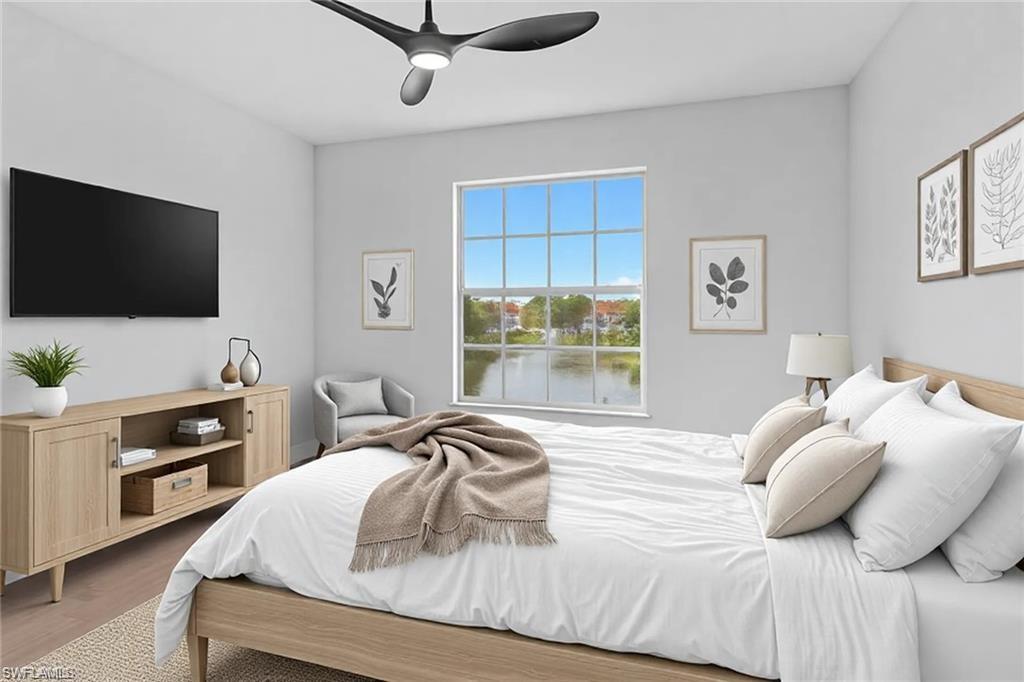 4720 St Croix Lane, Unit 135 Naples, FL 34109 - Photo 5 of 24 a bedroom with a bed and a flat screen tv