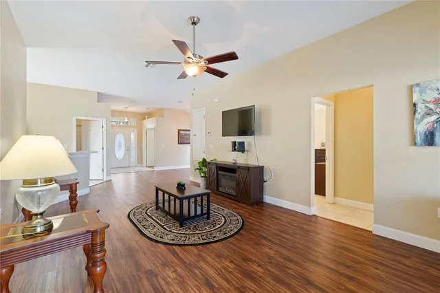 a living room with furniture and a wooden floor