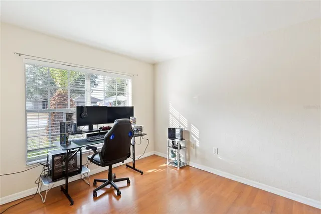 a view of a workspace with furniture and a window