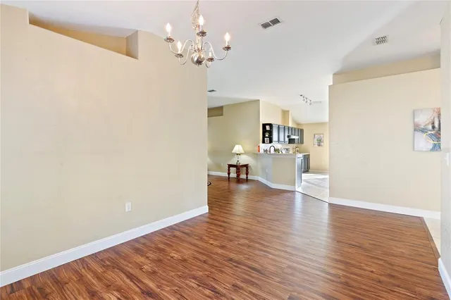 a view of a kitchen with wooden floor and a kitchen