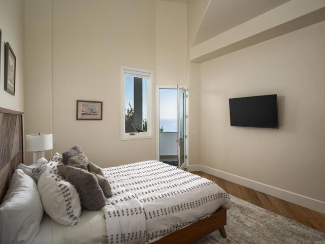 a bedroom with a bed and a flat screen tv
