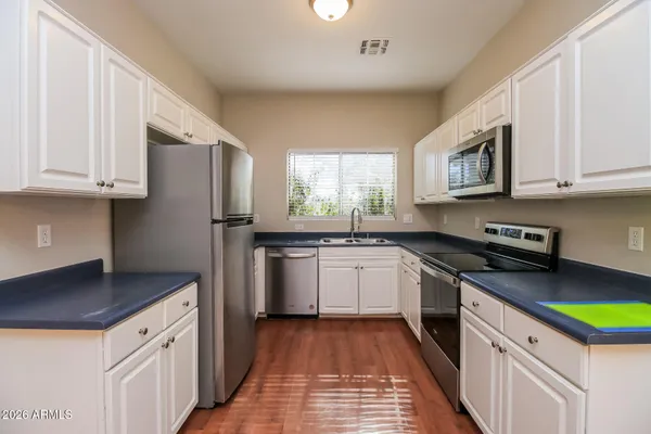 a kitchen with a sink stove and refrigerator