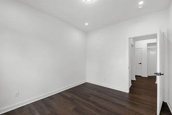 a view of a room with wooden floor