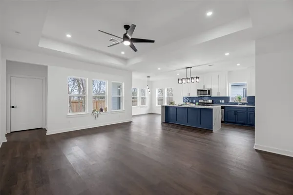 a view of kitchen and hall with wooden floor