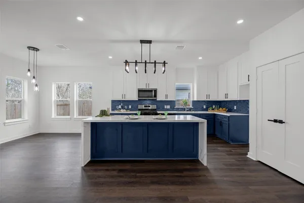 a kitchen with stainless steel appliances granite countertop a stove and a refrigerator